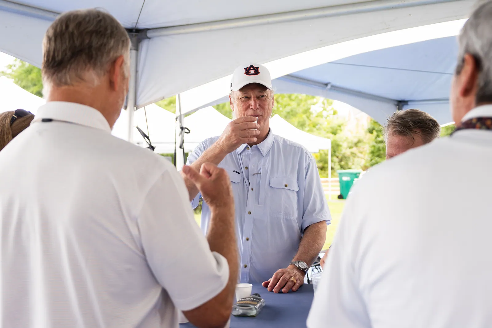 Weighing a sample under the Ambush tent. The three were poured blind and labeled only A, B and C.