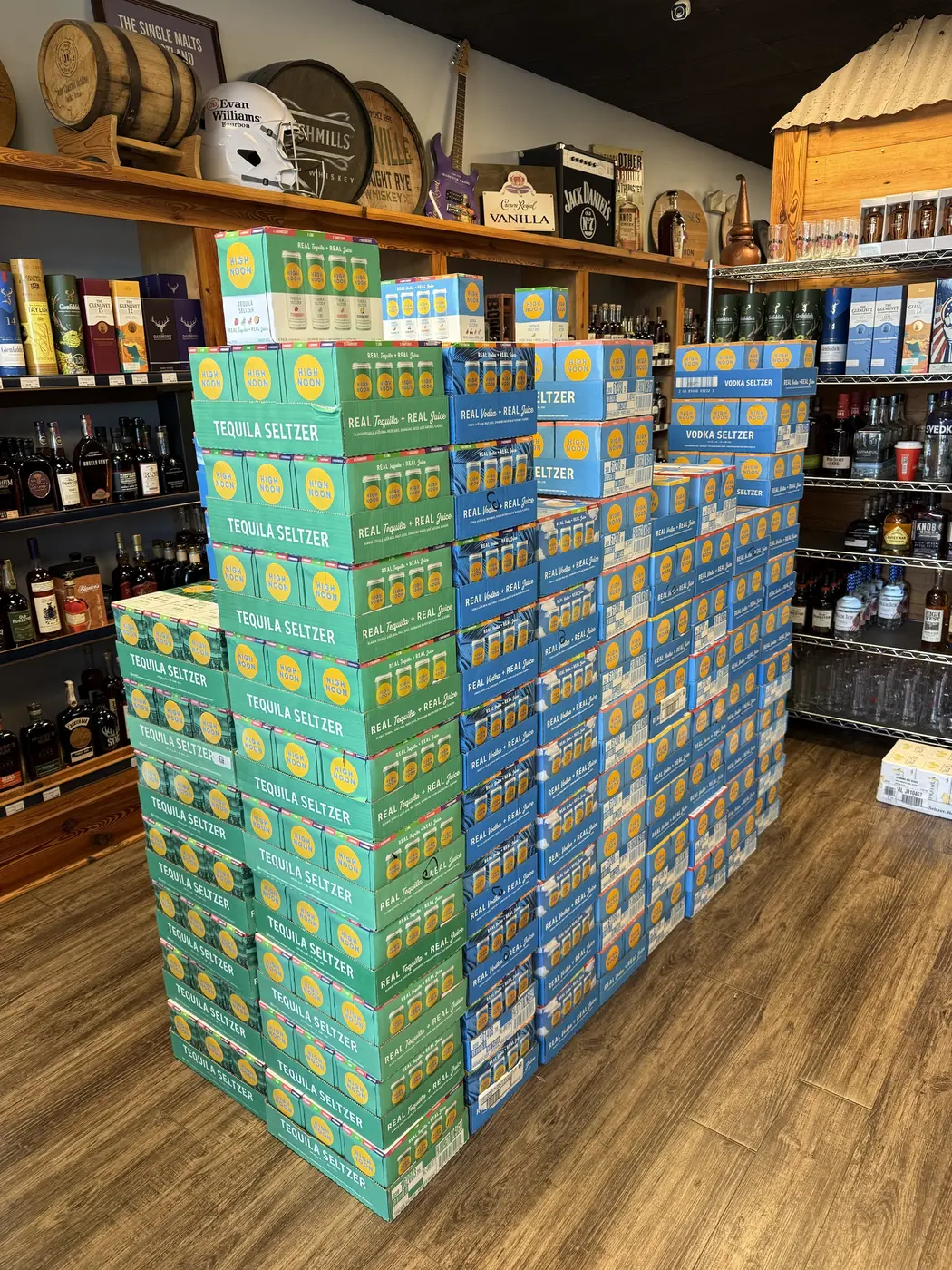 High Noon tequila seltzer and vodka seltzer cases beside the bourbon shelf